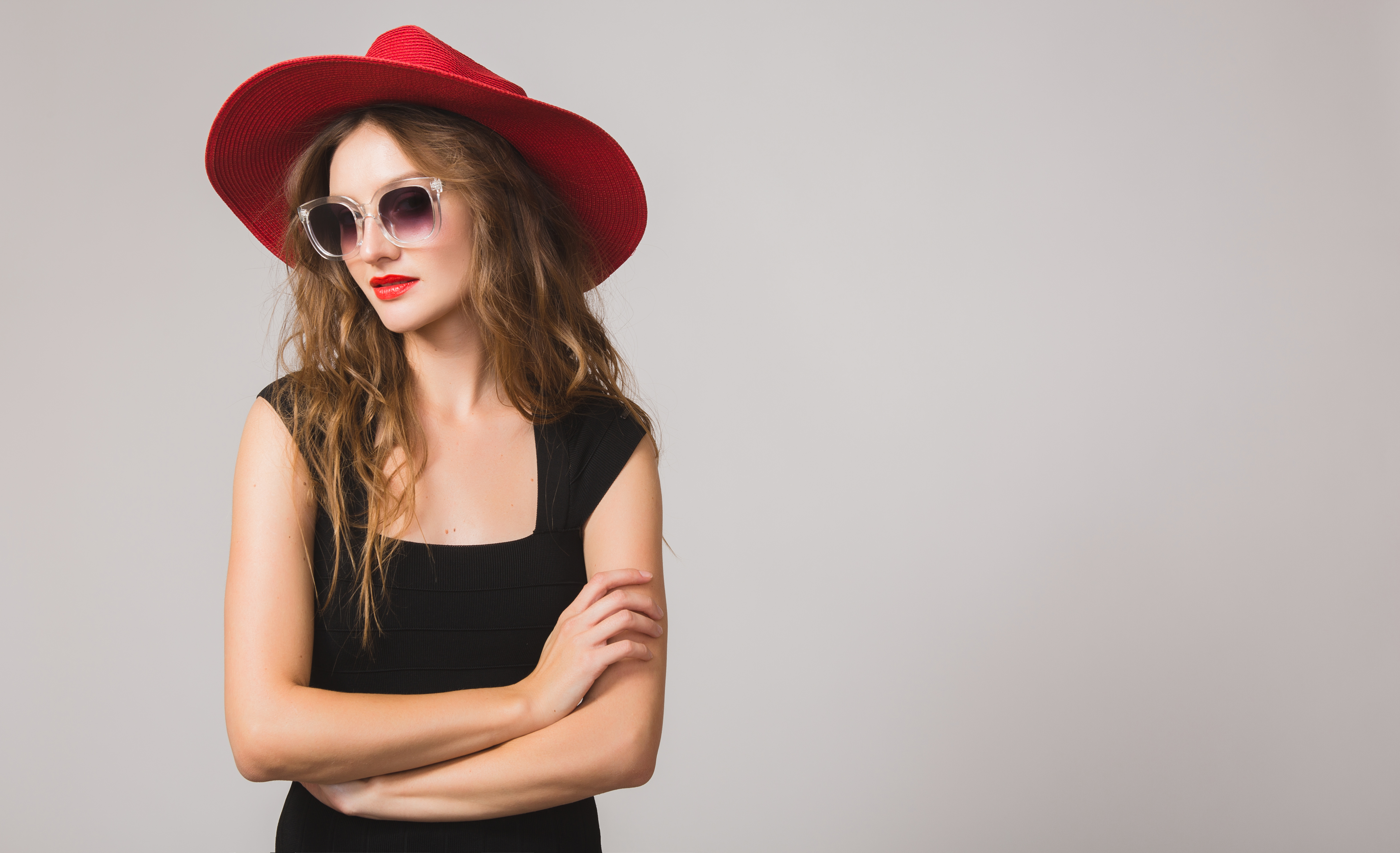 young beautiful stylish woman in black dress, red hat, sunglasses, red lipstick, happy, smiling, sexy, elegant